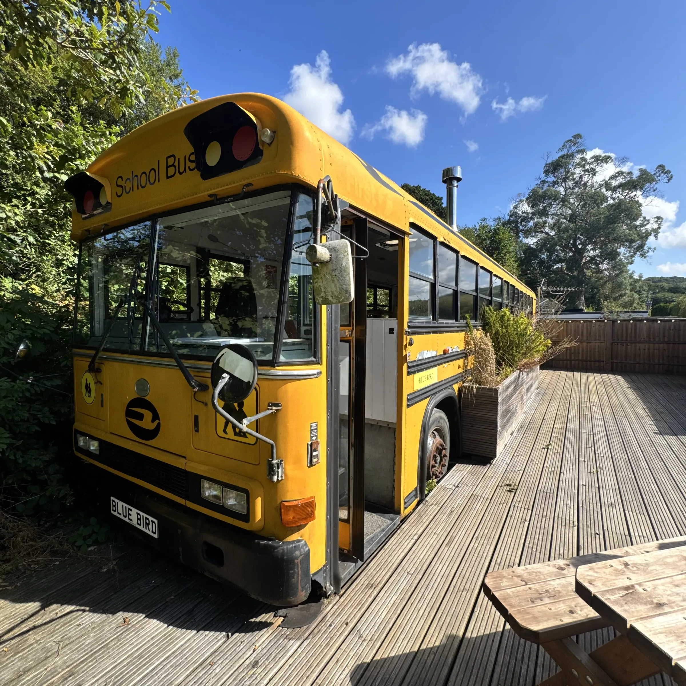 The front of the school bus with its picnic bench on the deck alongside