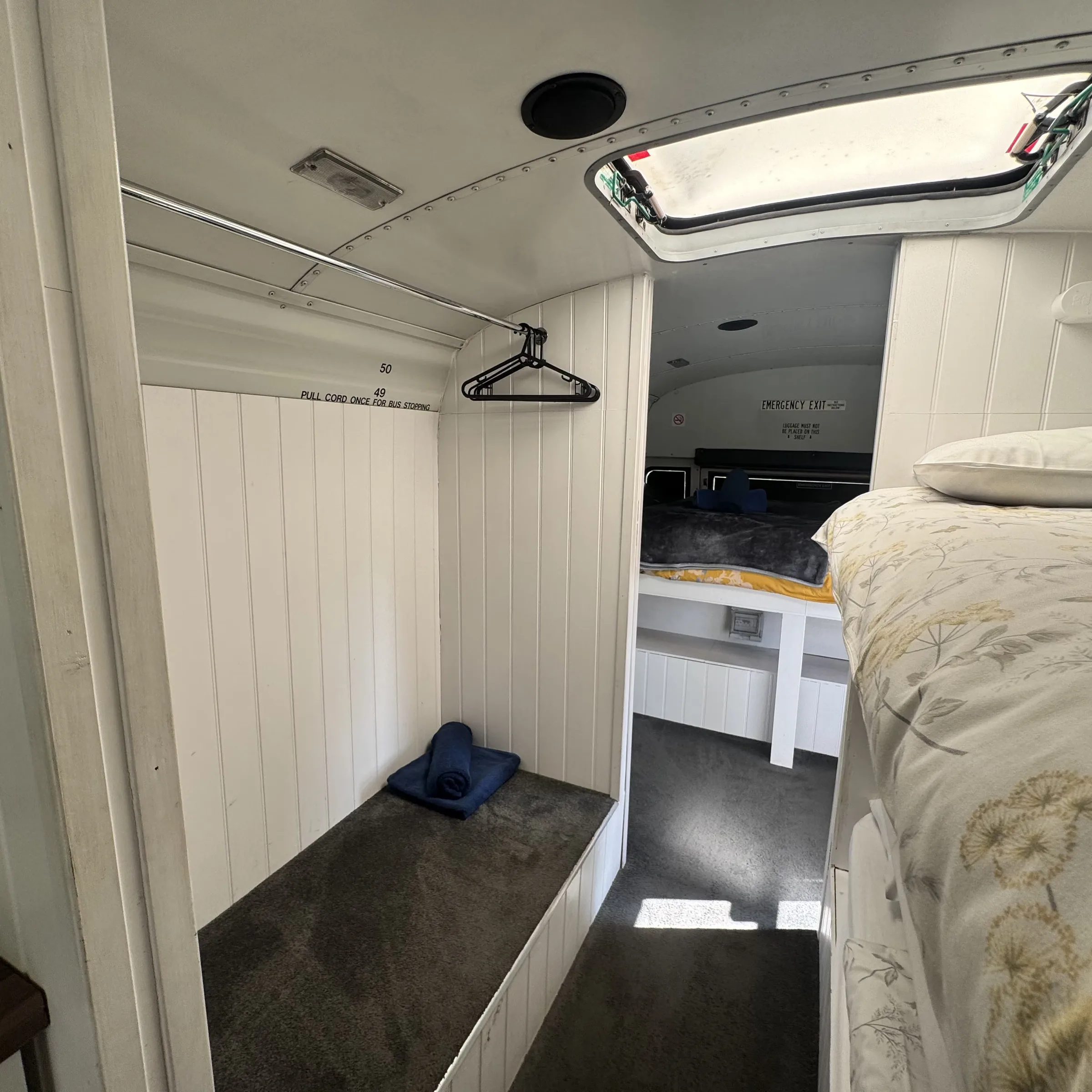 The hanging space and dressing area between the bunks and the double bed