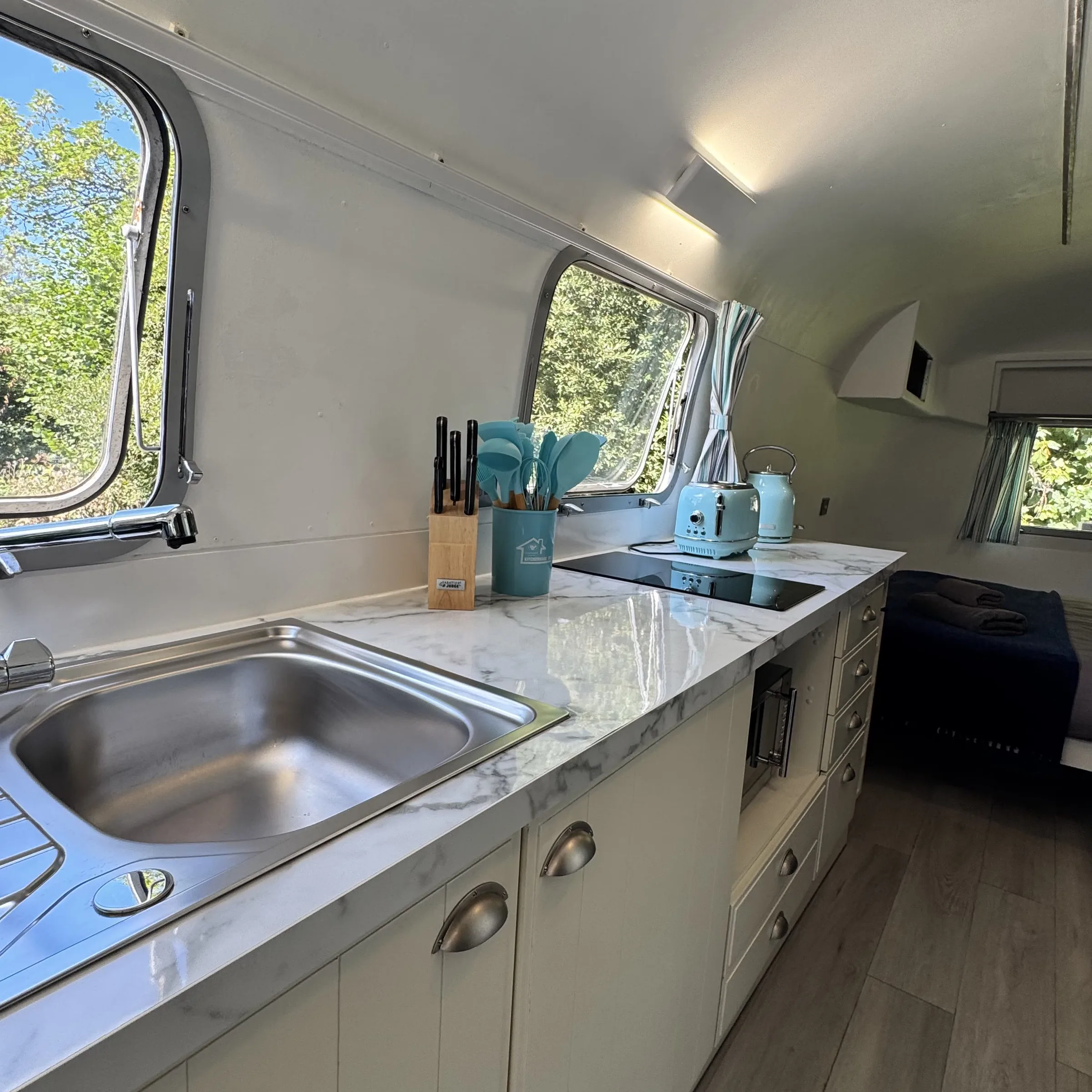 The Airstream’s kitchen, with a worktop, sink and storage under the curved window