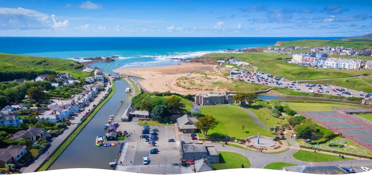 An aerial panorama of Bude, showing the canal, Summerleaze beach, the sea pool and the town beyond