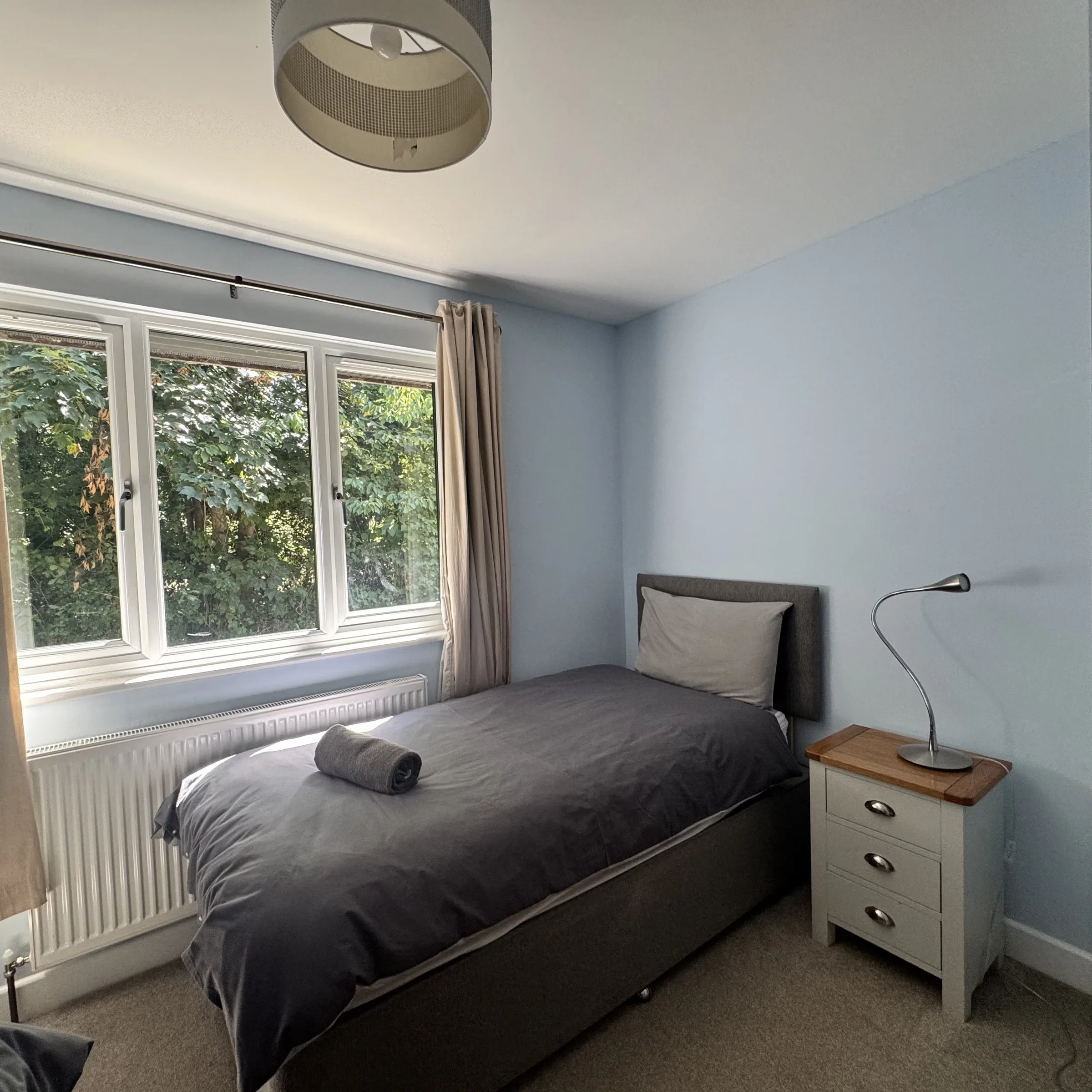 A second view of the twin room at Heath, with the bedside chest and lamp