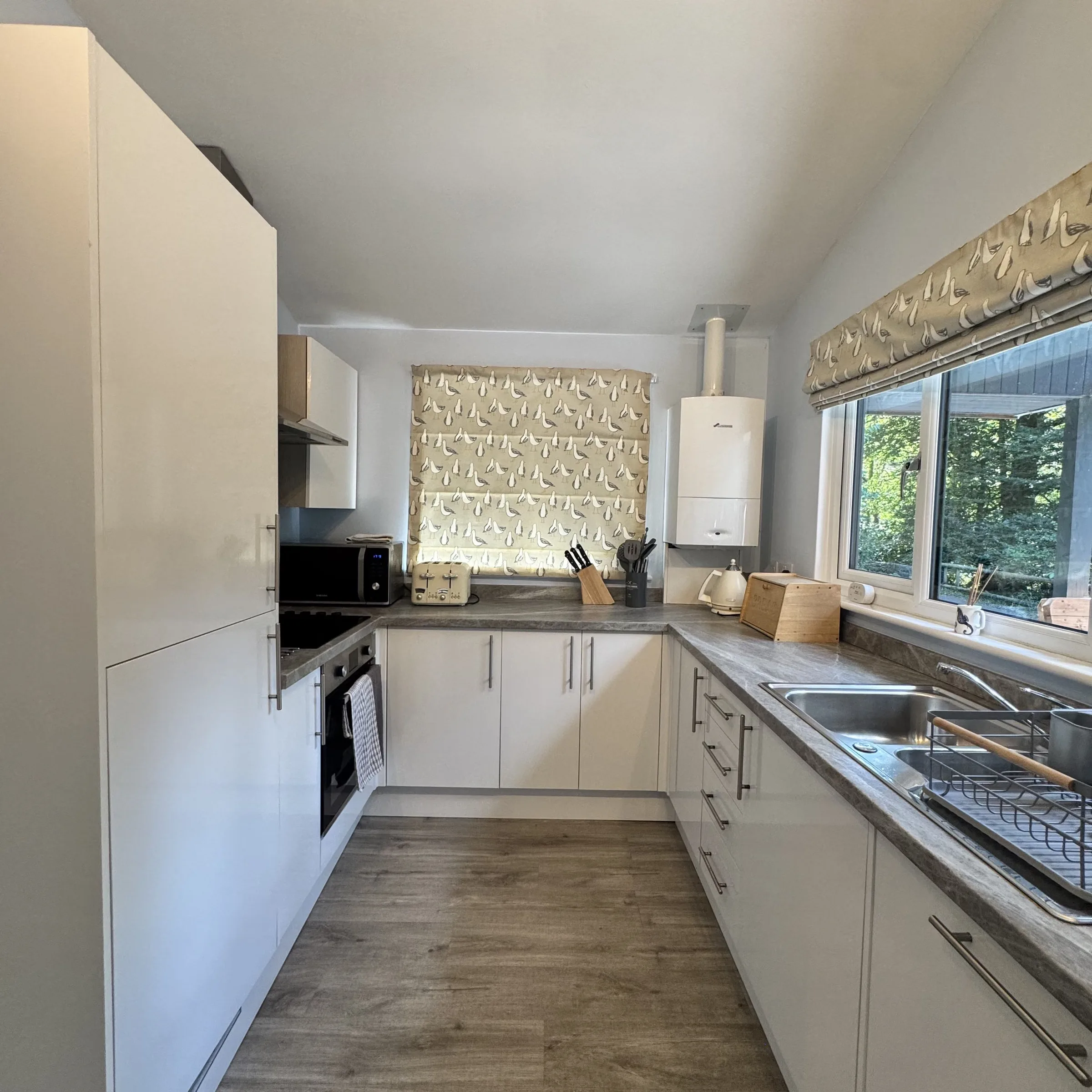 The galley kitchen at Heath, with oven, worktops and a window over the counter