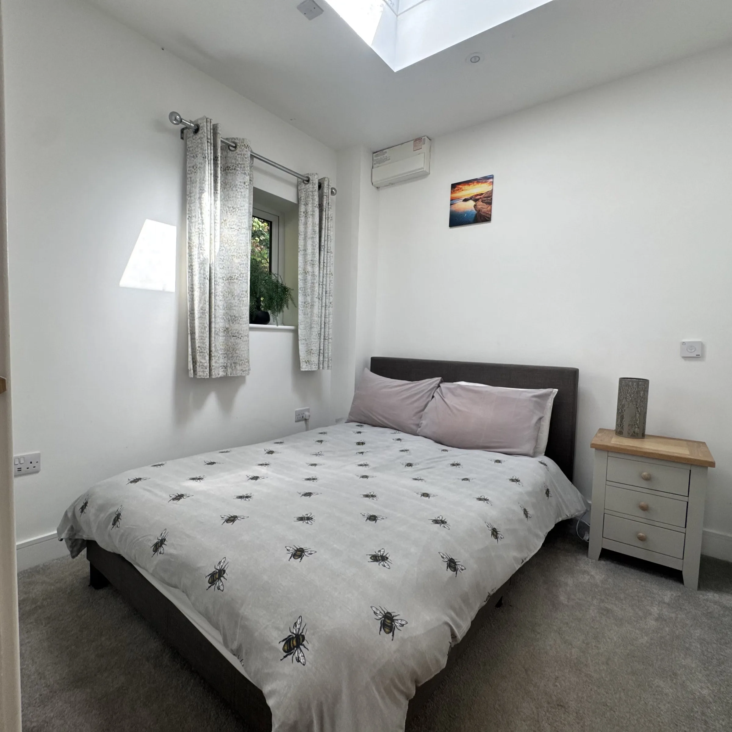 The double bedroom at Helyk, made up, with a window and skylight above