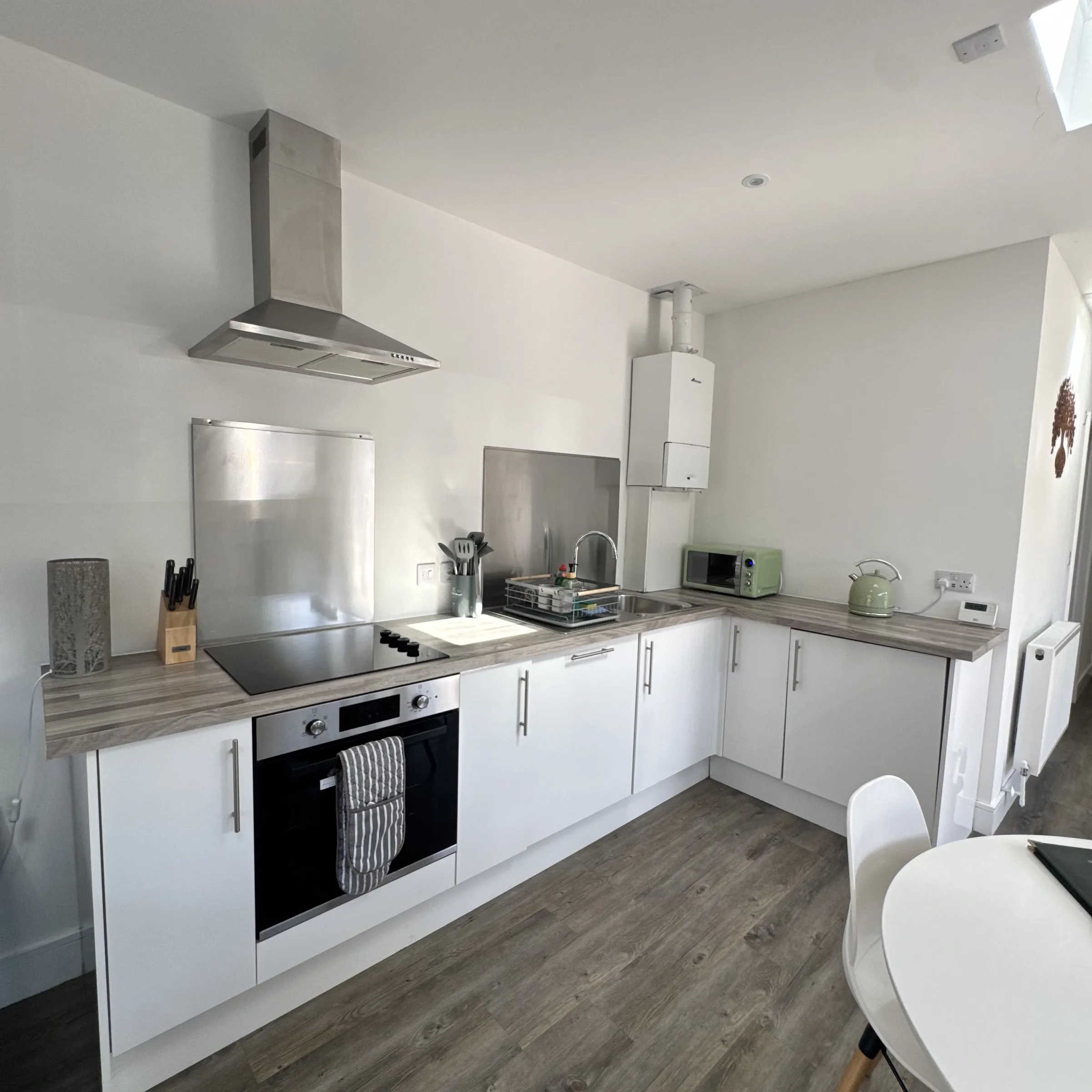 The kitchen at Helyk, with induction hob, oven, sink and microwave