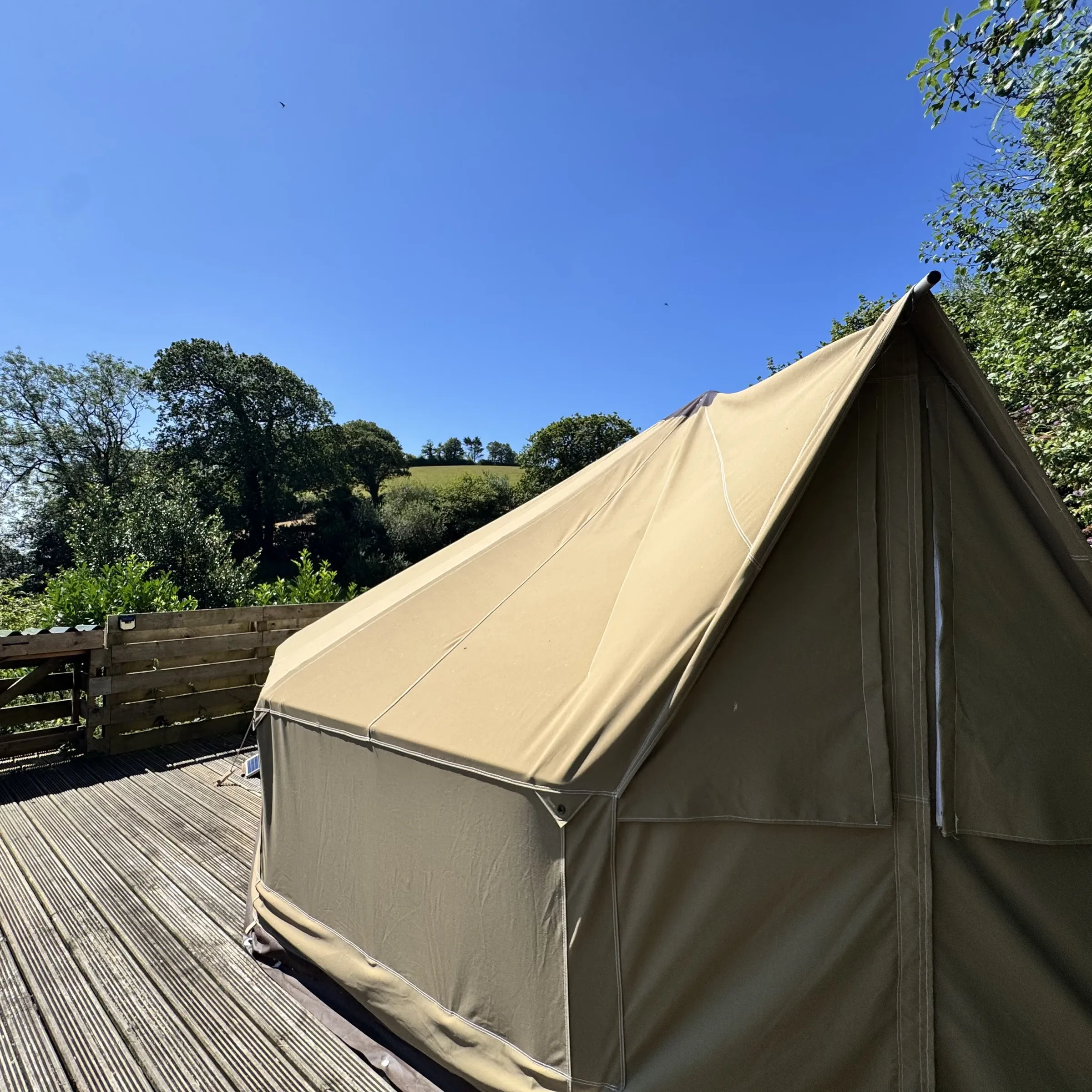 Sea Campion’s bell tent on its timber deck, with the countryside falling away behind