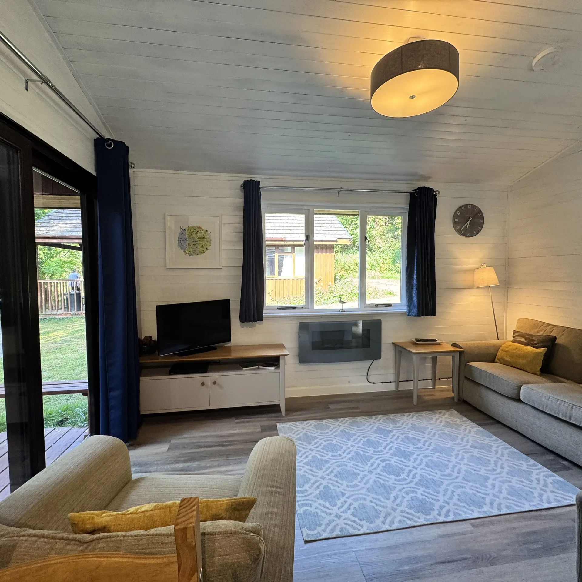 The living area at Stamford with sofa, TV and soft furnishings