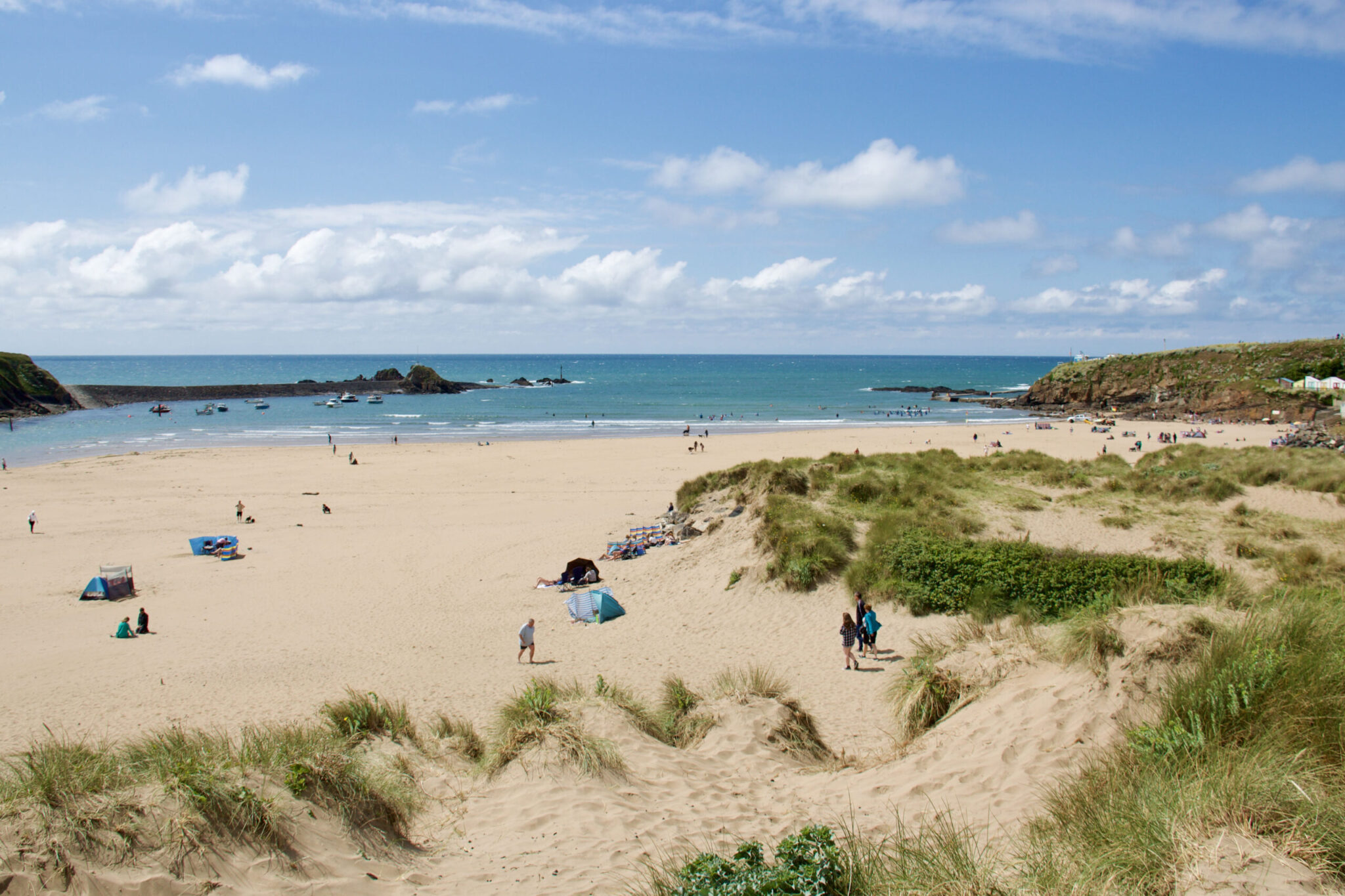 A beginners' surf lesson on Summerleaze Beach, Bude, with learners and boards on the sand
