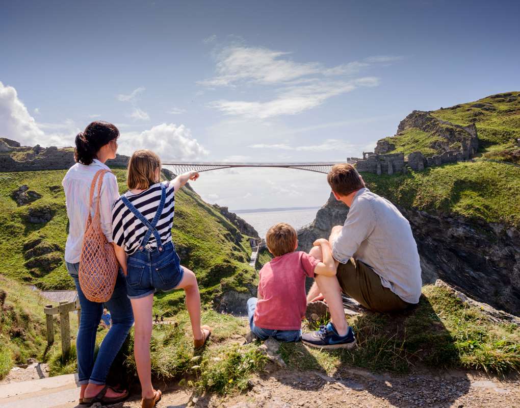 A family exploring the clifftop ruins of Tintagel Castle on the North Cornwall coast